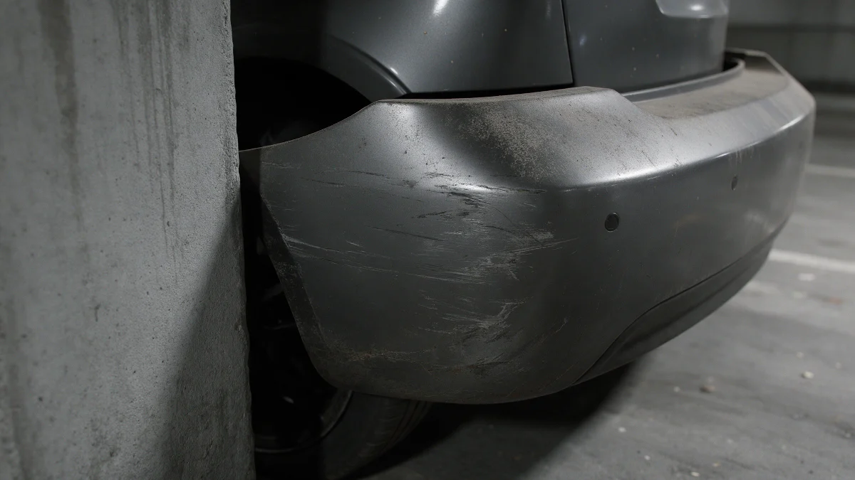 Scuffed rear bumper corner on a car parked in a multi-storey bay